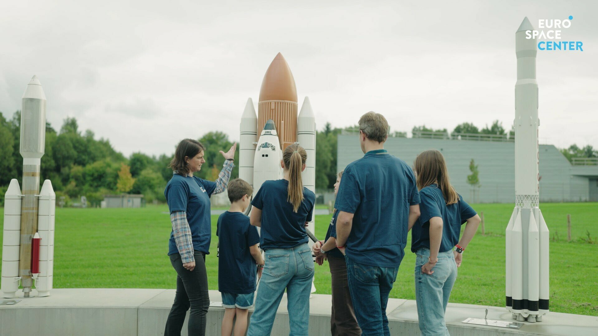 A family seen from behind looking at rockets