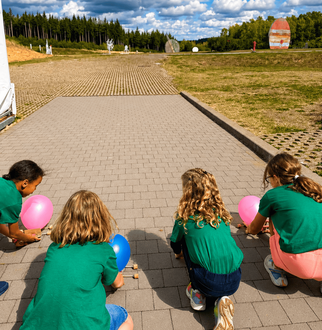 Children participating in an outdoor balloon car race