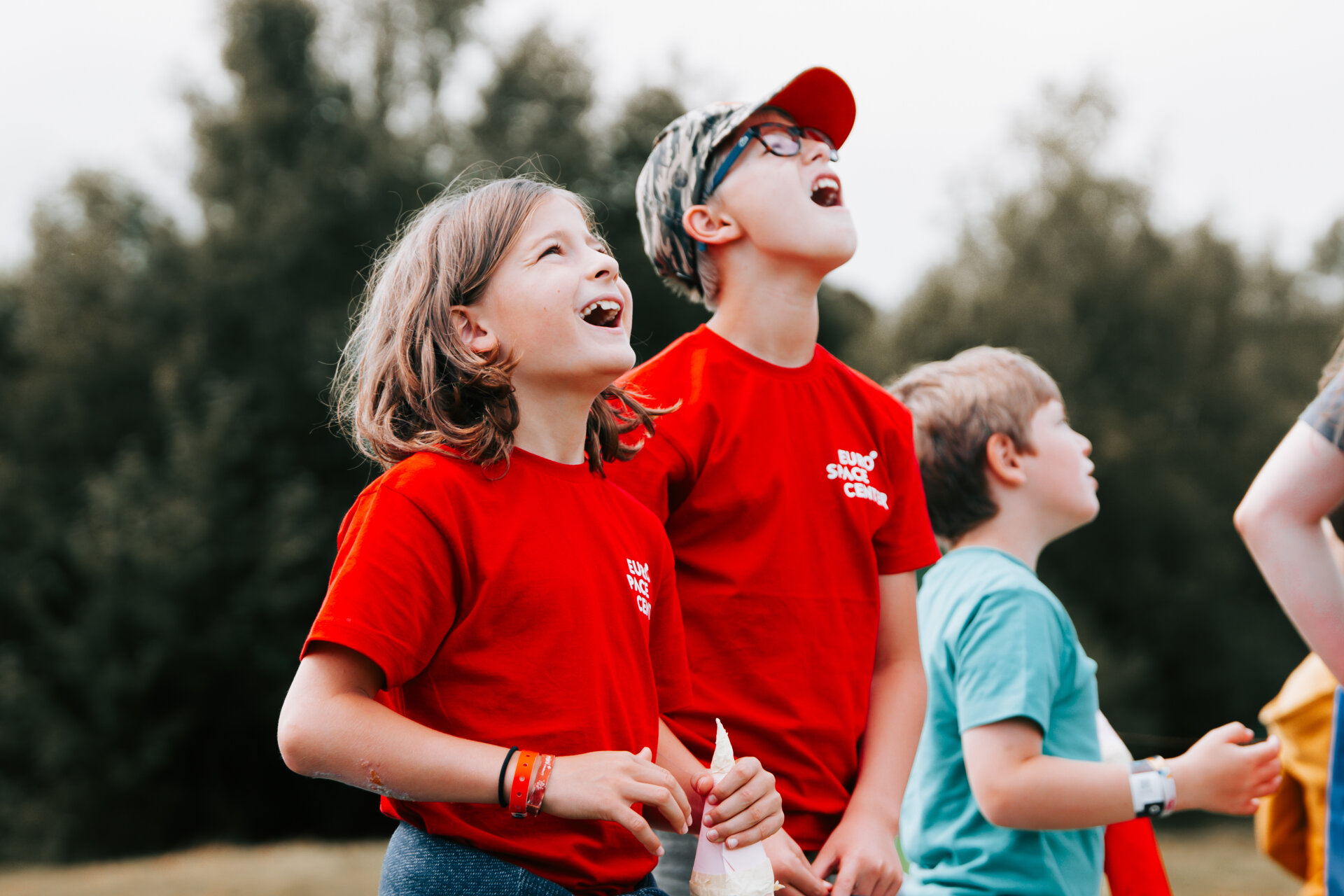Two children amazed by what they see in the sky