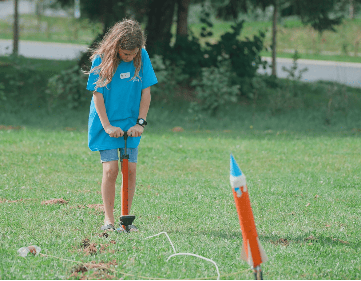 Child preparing to launch their water rocket