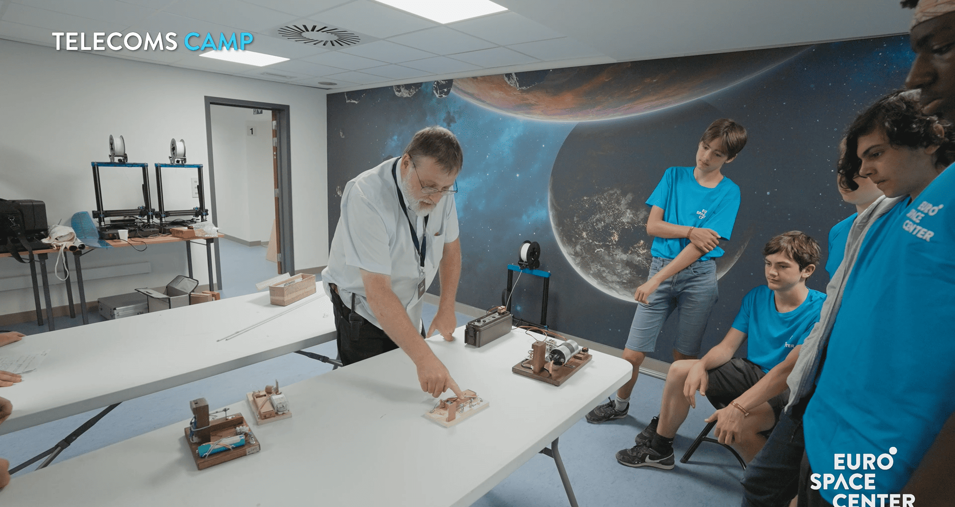 A group listening to the Space Monitor talk about telecommunications